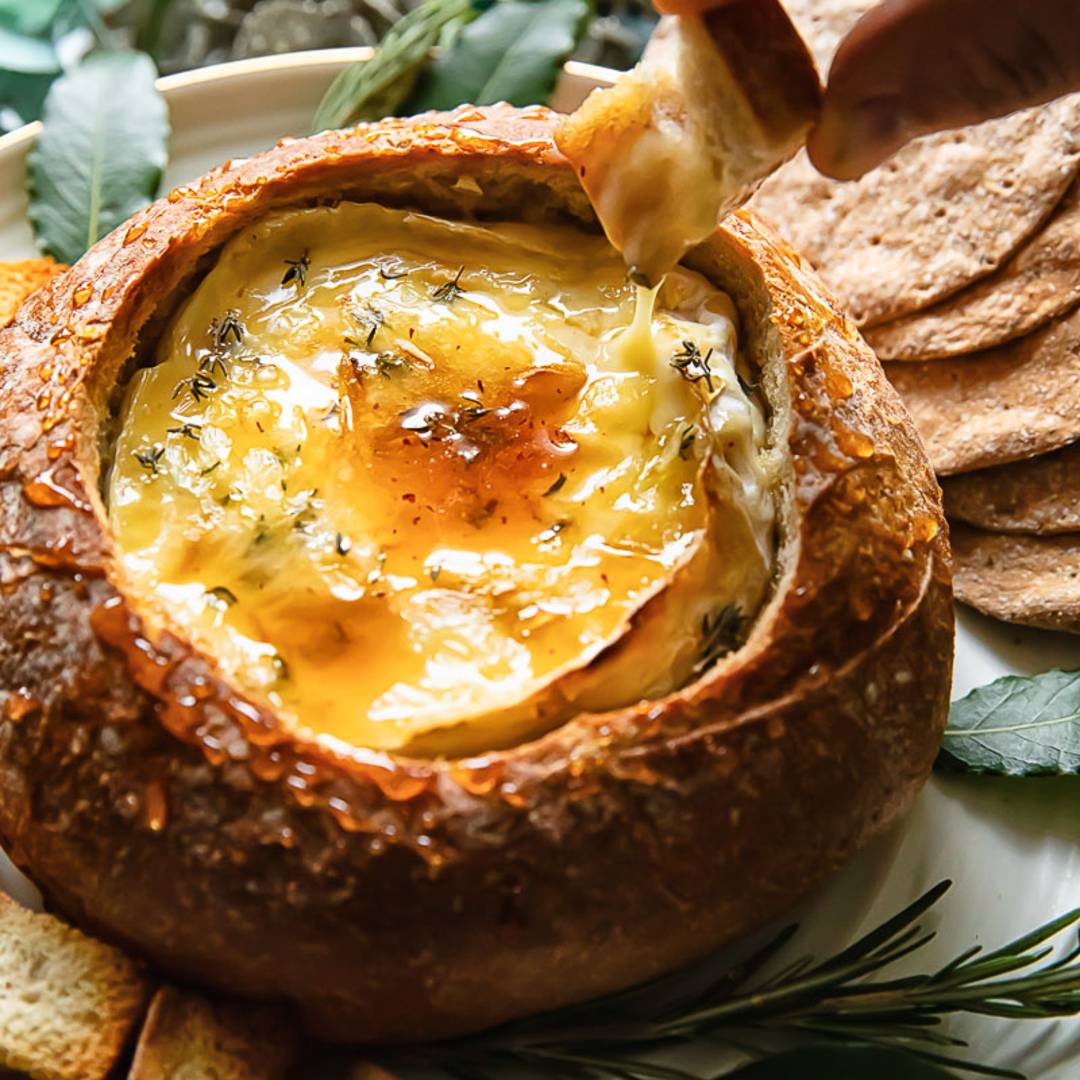 small bread with made into a bowl and filled with a round of camembert