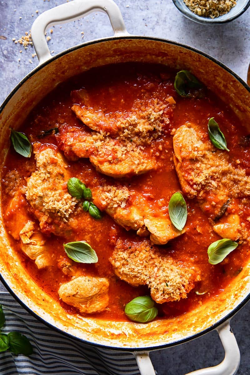 pan with chicken breasts in a red sauce