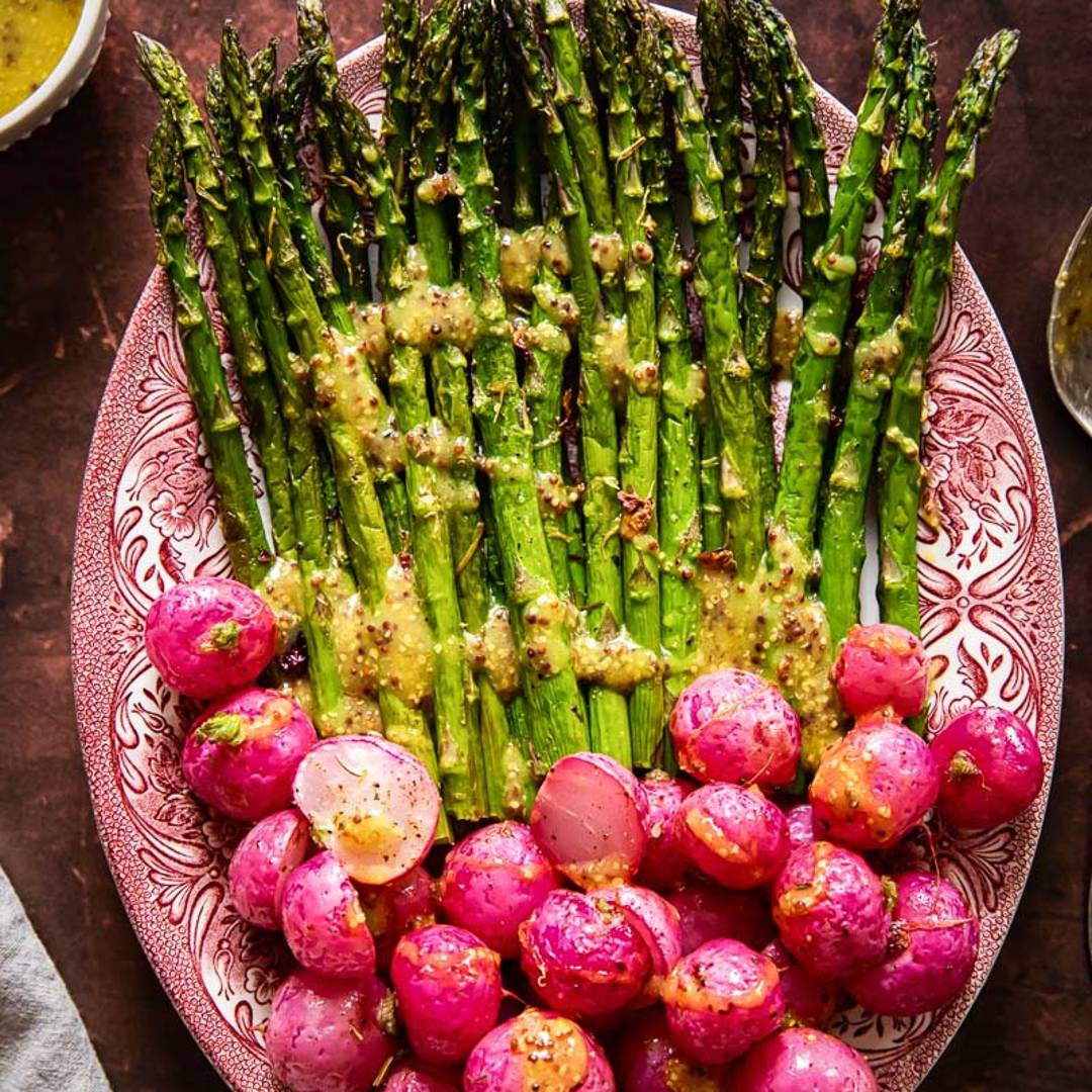 serving splatter with a pile of asparagus on one half, and radishes on the other