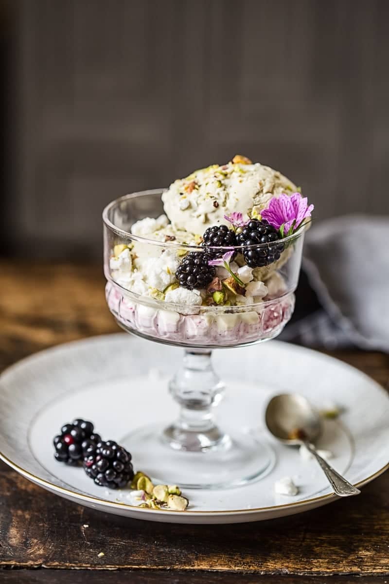 stemmed glass with pistachio ice cream and blackberries
