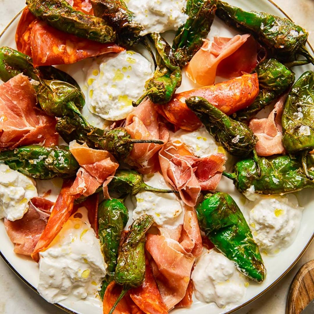plate with padron peppers, oozy cheese and meat slices