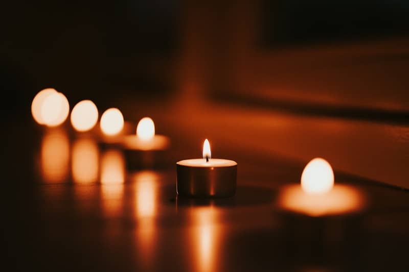 Candles glow warmly in the dim light.