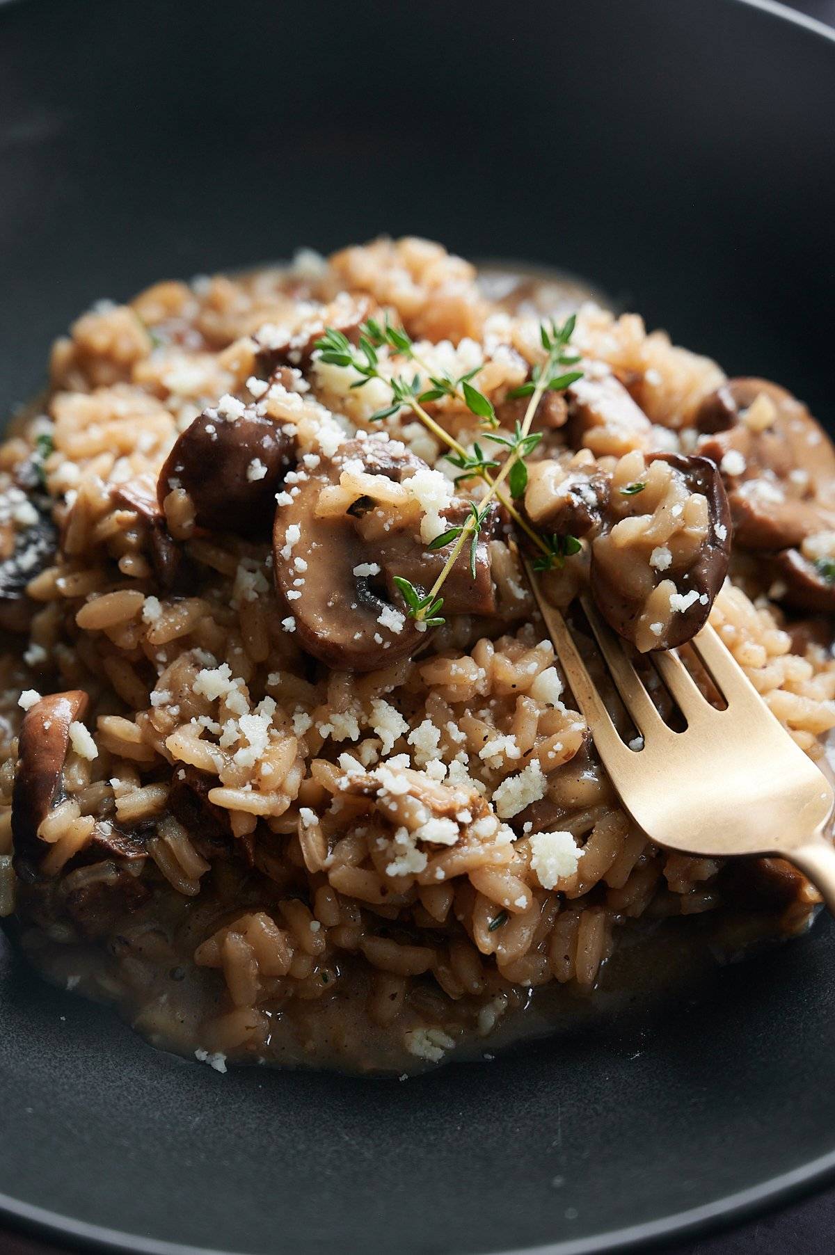 fork digging into mushroom risotto