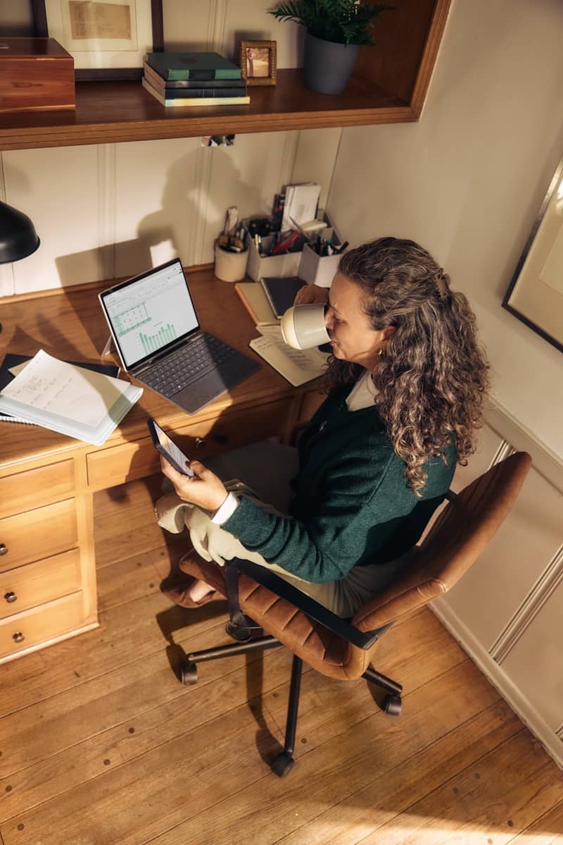 Woman working at a desk with laptop and tablet she's tired of trying to scale using other people's systems and not seeing success.