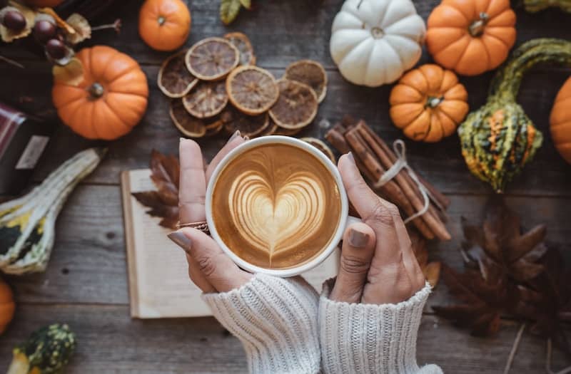 a person holding a cup of coffee with a heart on it Reminding us to stay grateful for our blessings, but to not forget those before us and among us who still continue to pay a heavy cost. 