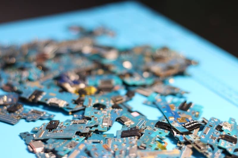 Electronic circuit boards are scattered across a surface complicating the ability to put the puzzle together. Are you making your business more complicated than it needs to be?
