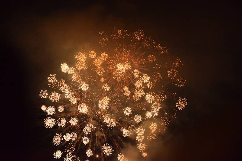 Golden fireworks exploding against a dark sky