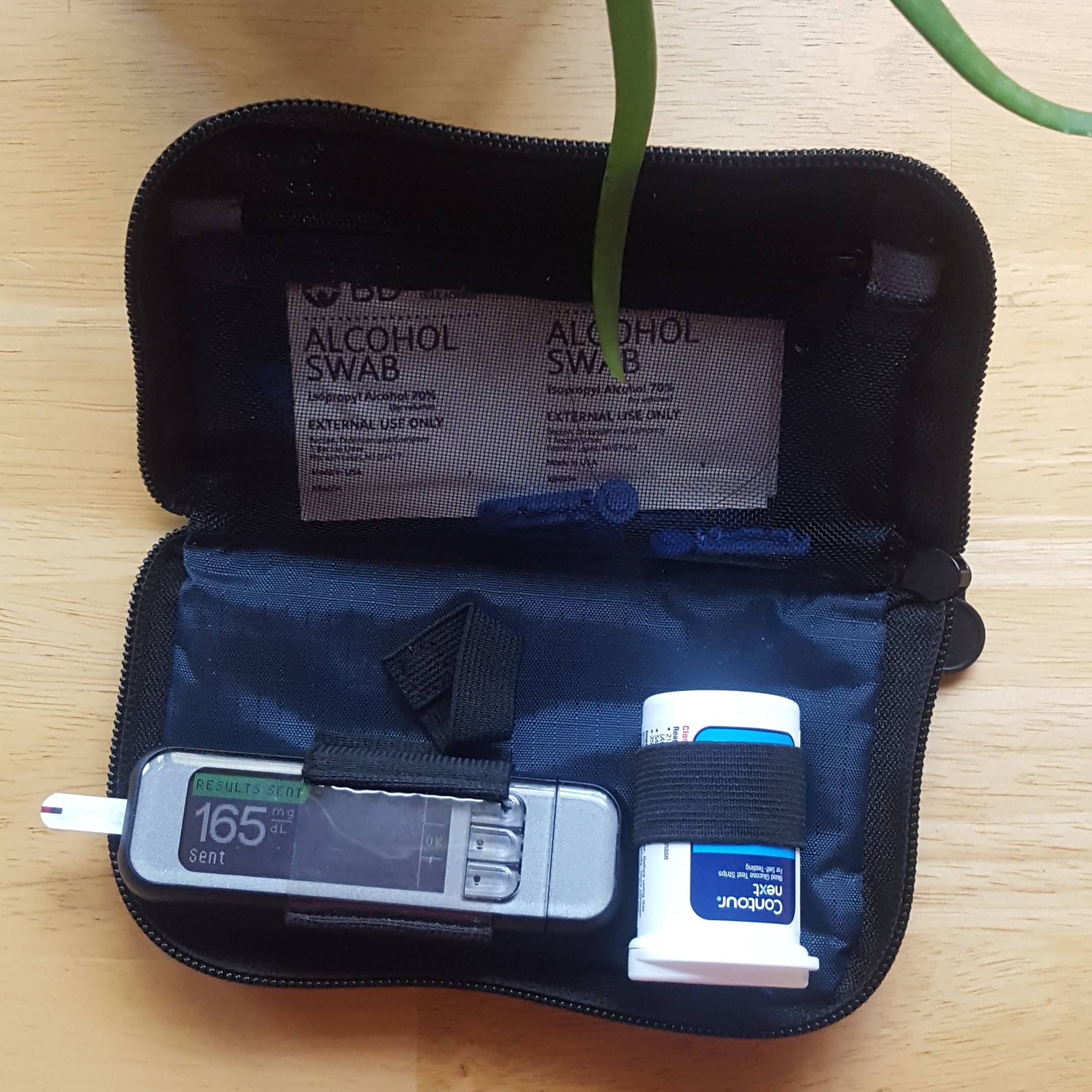 black smartphone beside white plastic bottle and black smartphone
