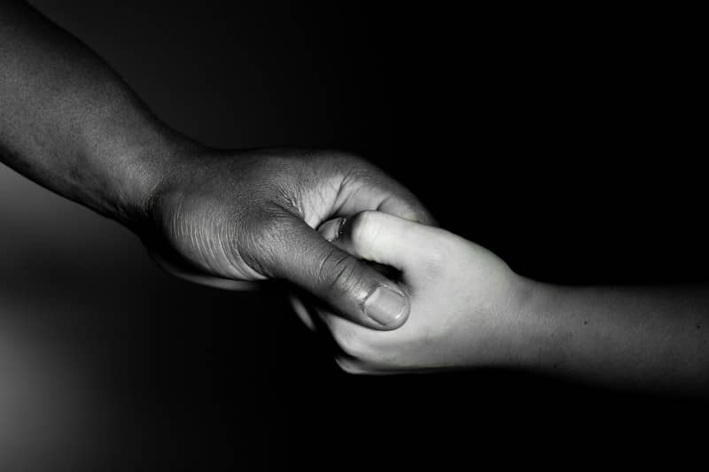 Two hands held together in a black and white close-up