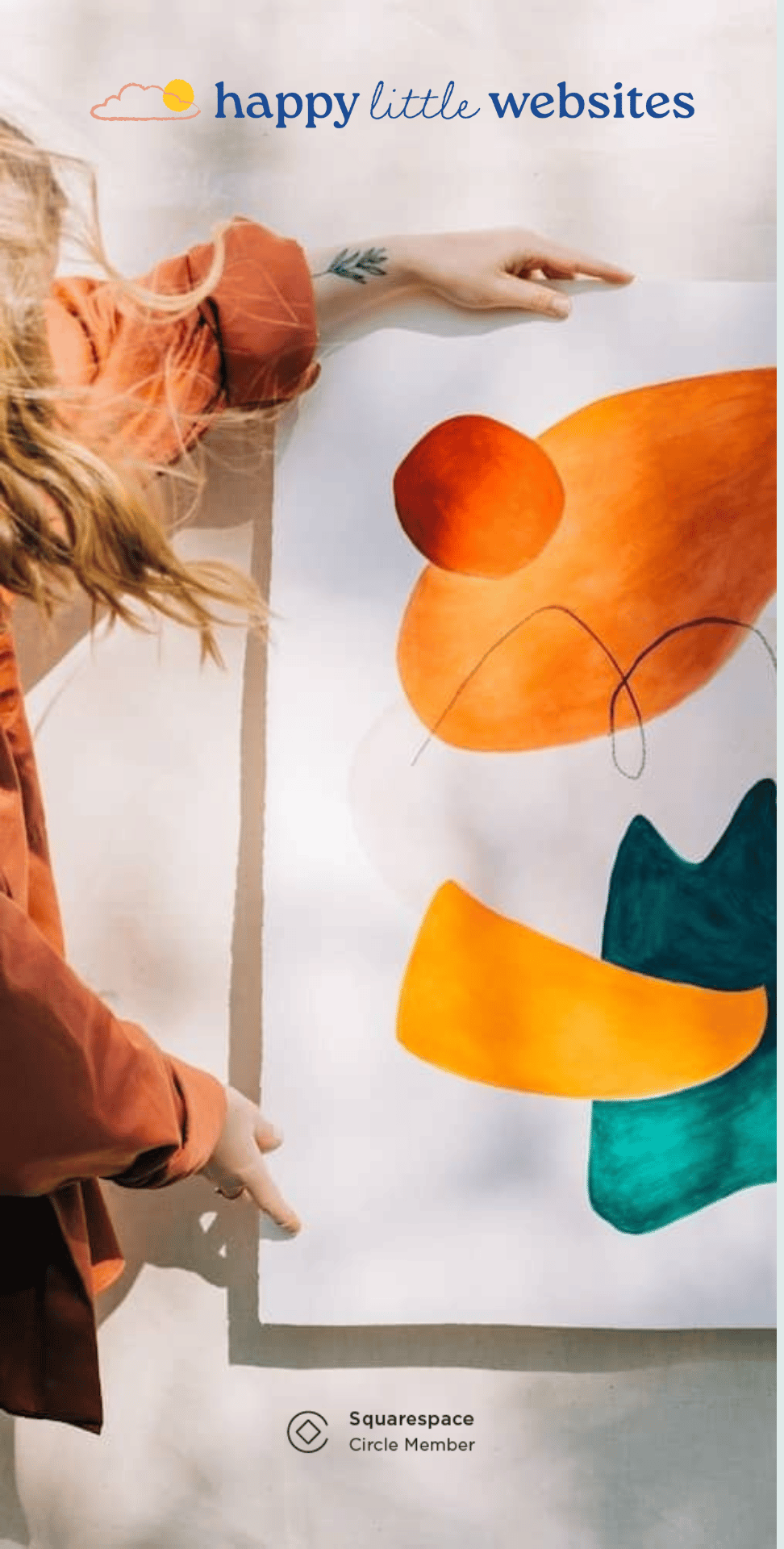 a woman holding a piece of paper with a painting on it