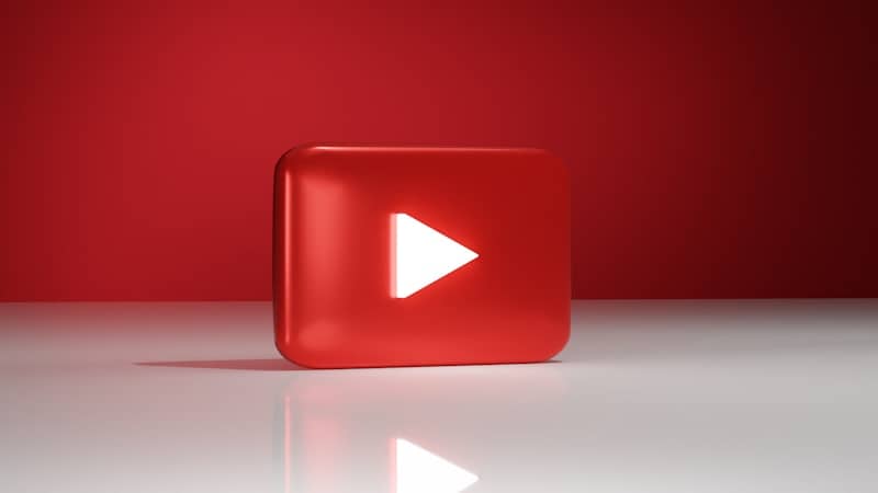 A red play button sitting on top of a white floor