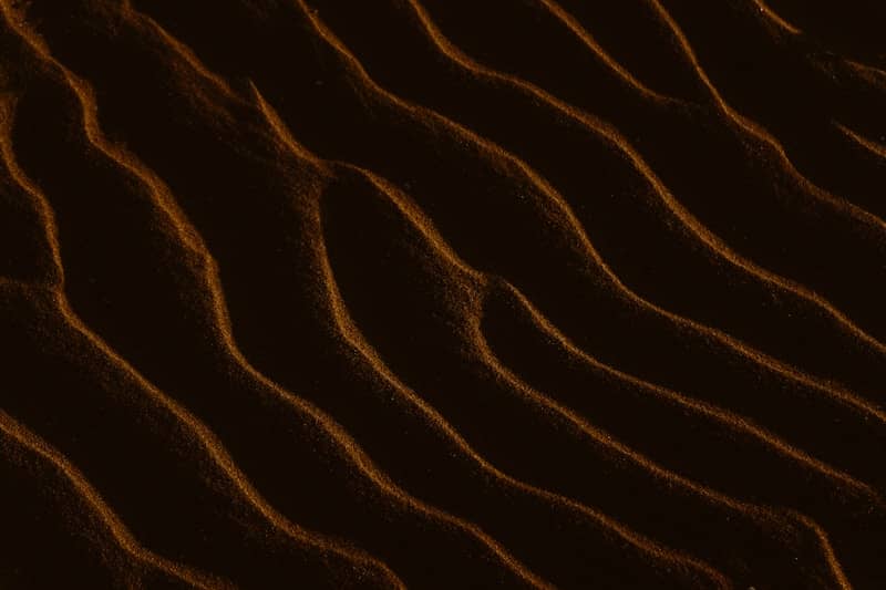 A close up of a sand dune at night
