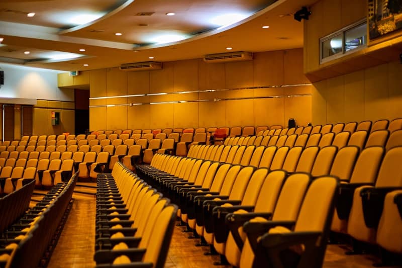 An auditorium is filled with empty seats.