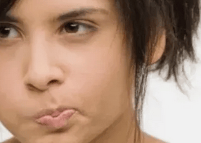 young lady swishing oil in her mouth