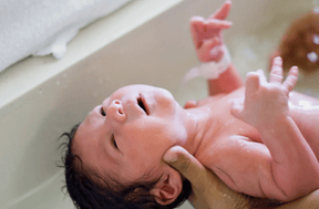 newborn born getting a bath