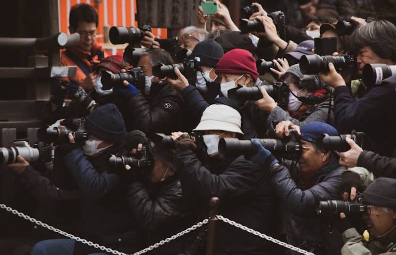 people in black jacket taking photo