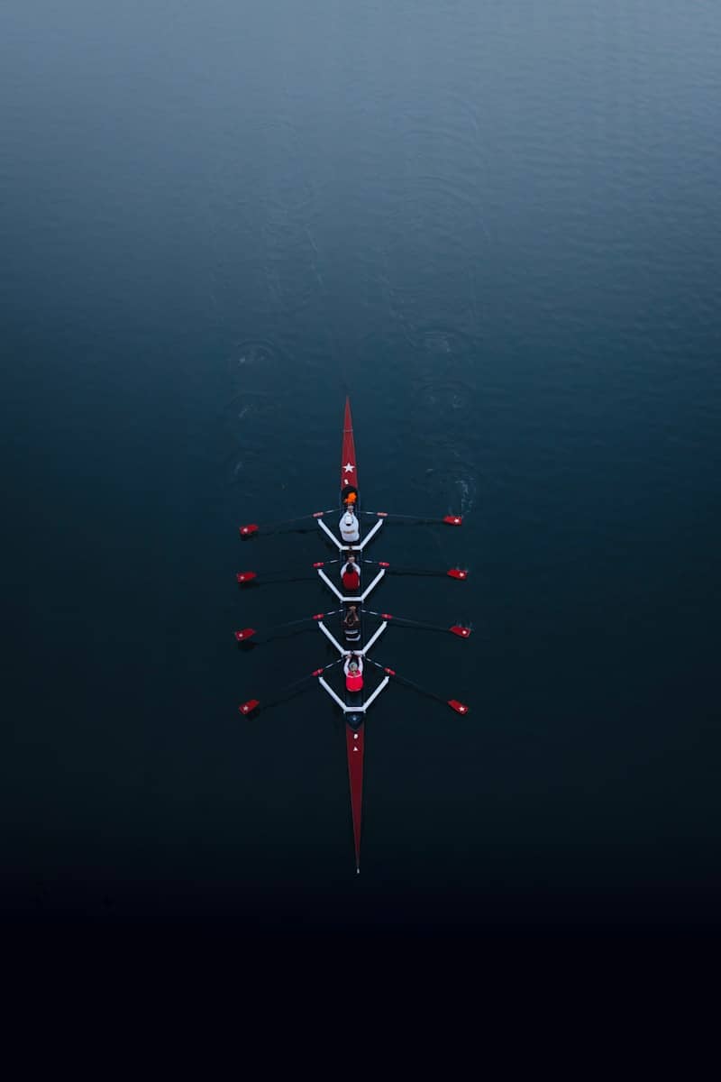 a row of boats floating on top of a body of water
