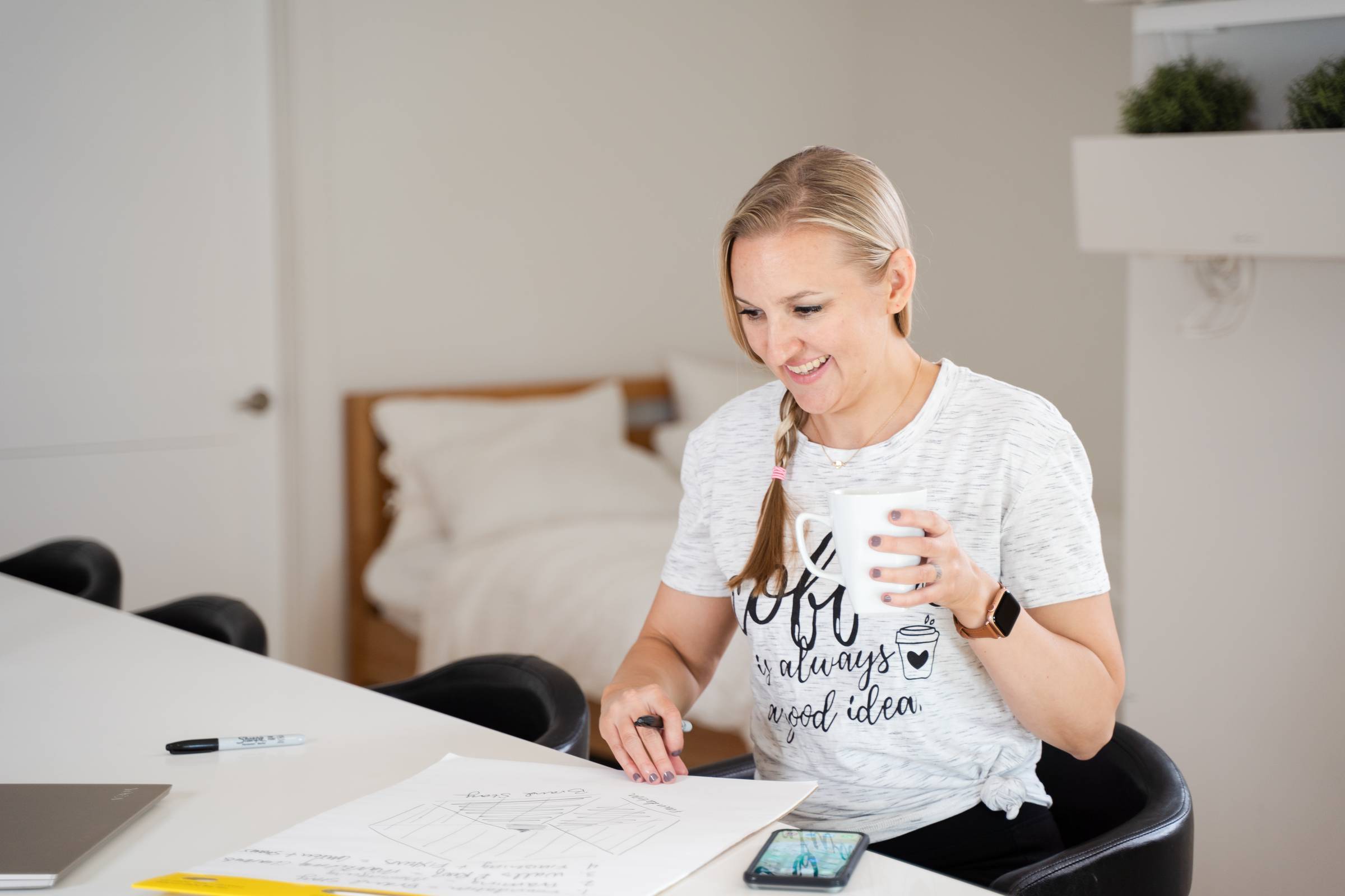 Erin writing on a notepad at the kitchen counter
