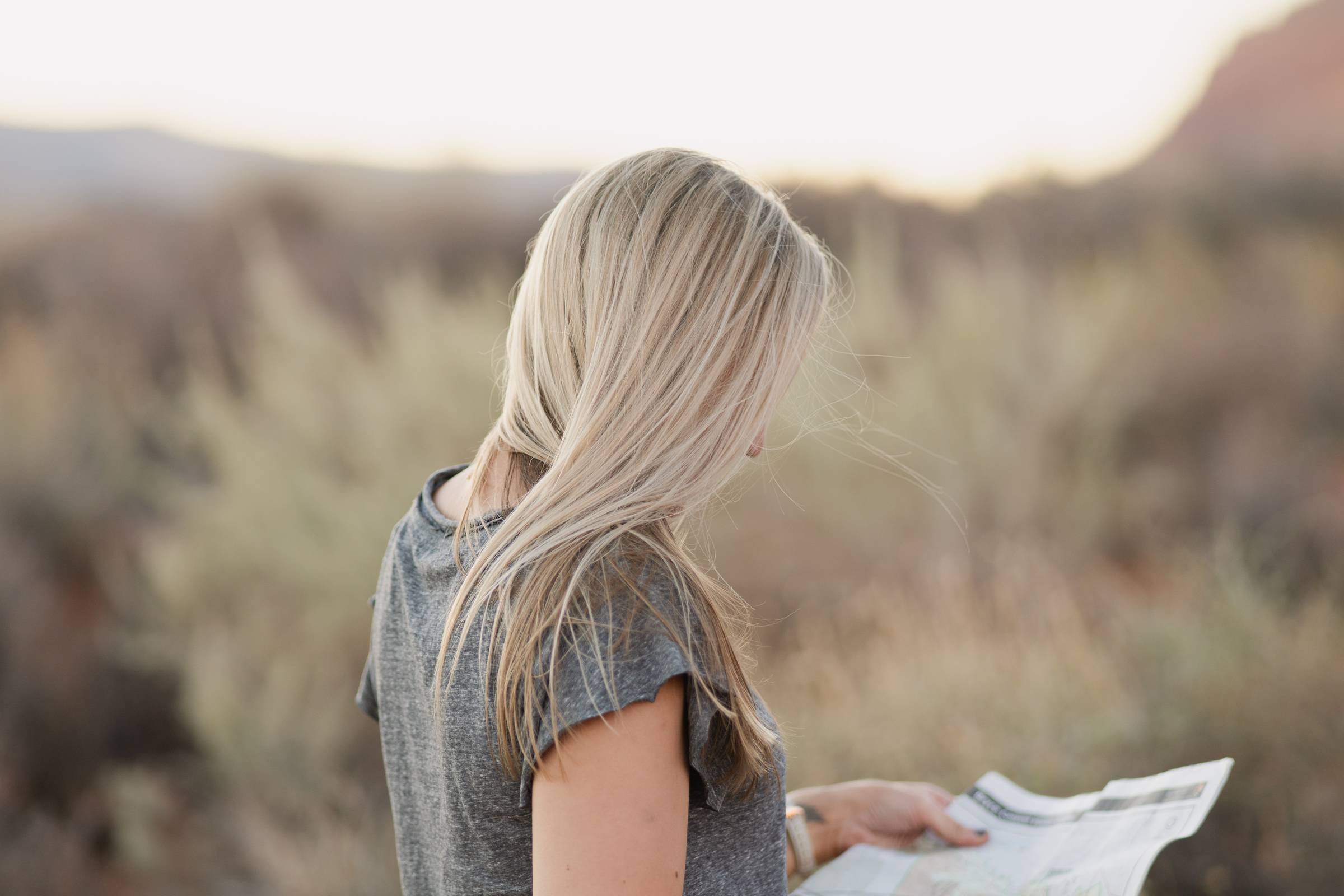 A woman looking at a map in a field
