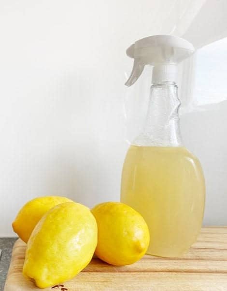yellow lemon fruit beside clear glass bottle