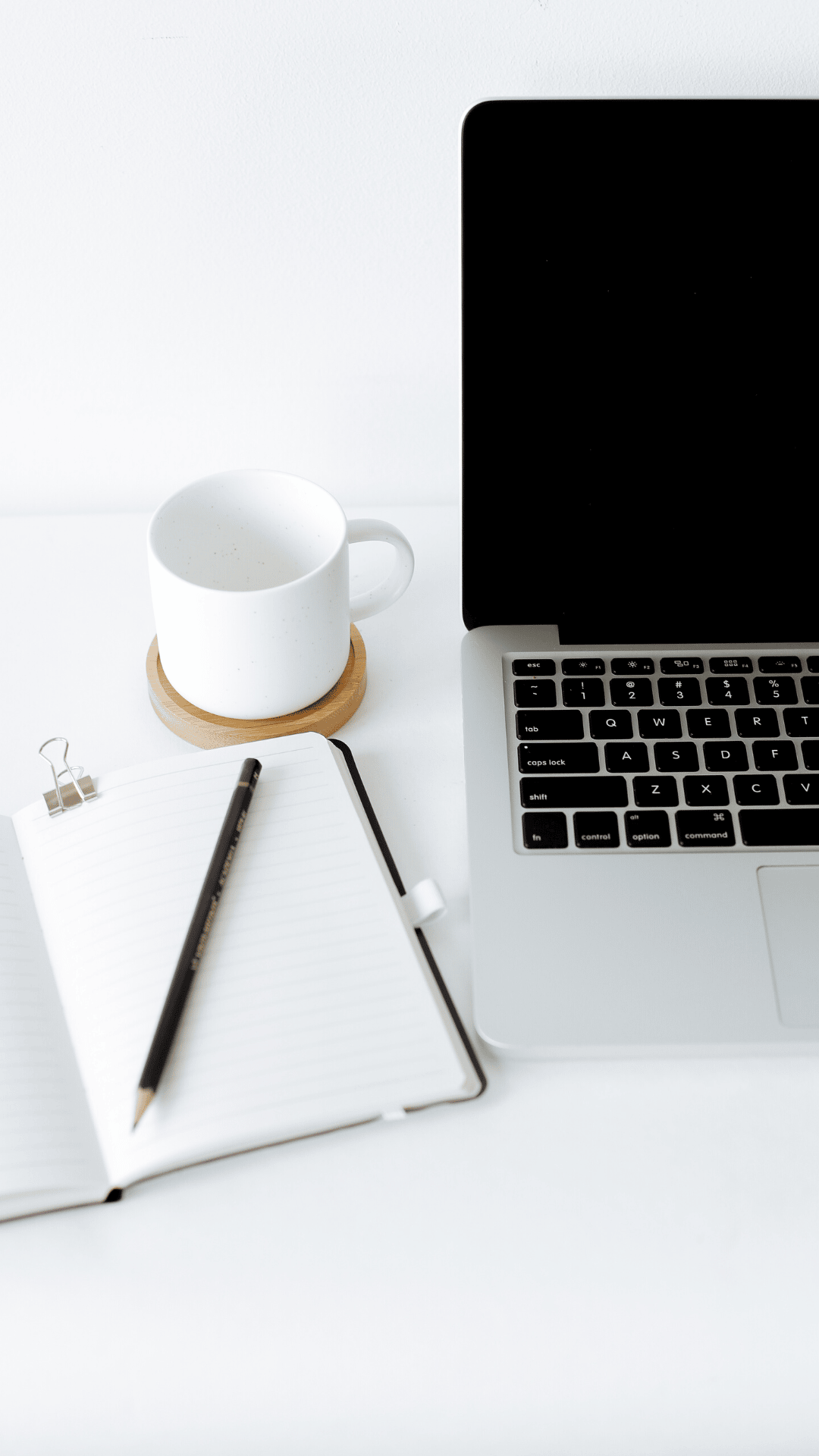 person typing on MacBook Pro on brown wooden table during daytime photo