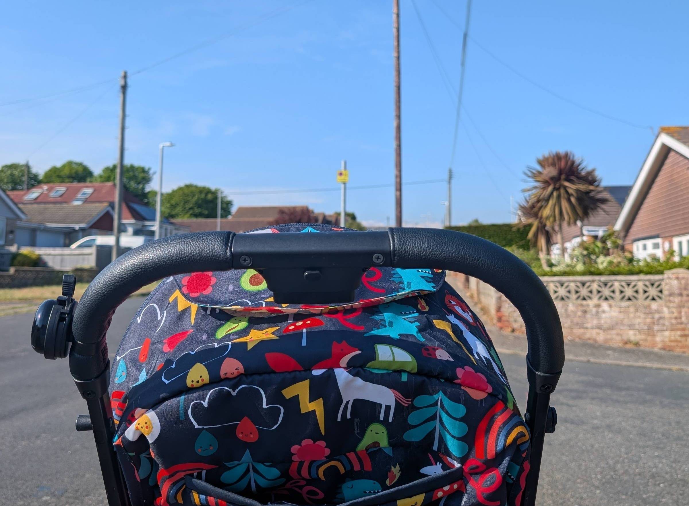 The back of colourful pushchair on an empty street