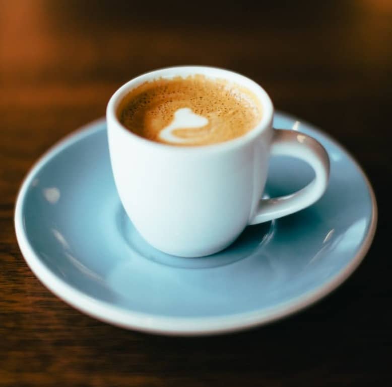 selective focus photography of latte in teacup