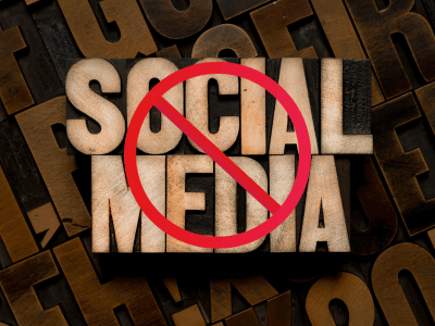 Wooden block text saying no socials with red circle with line through it over the top