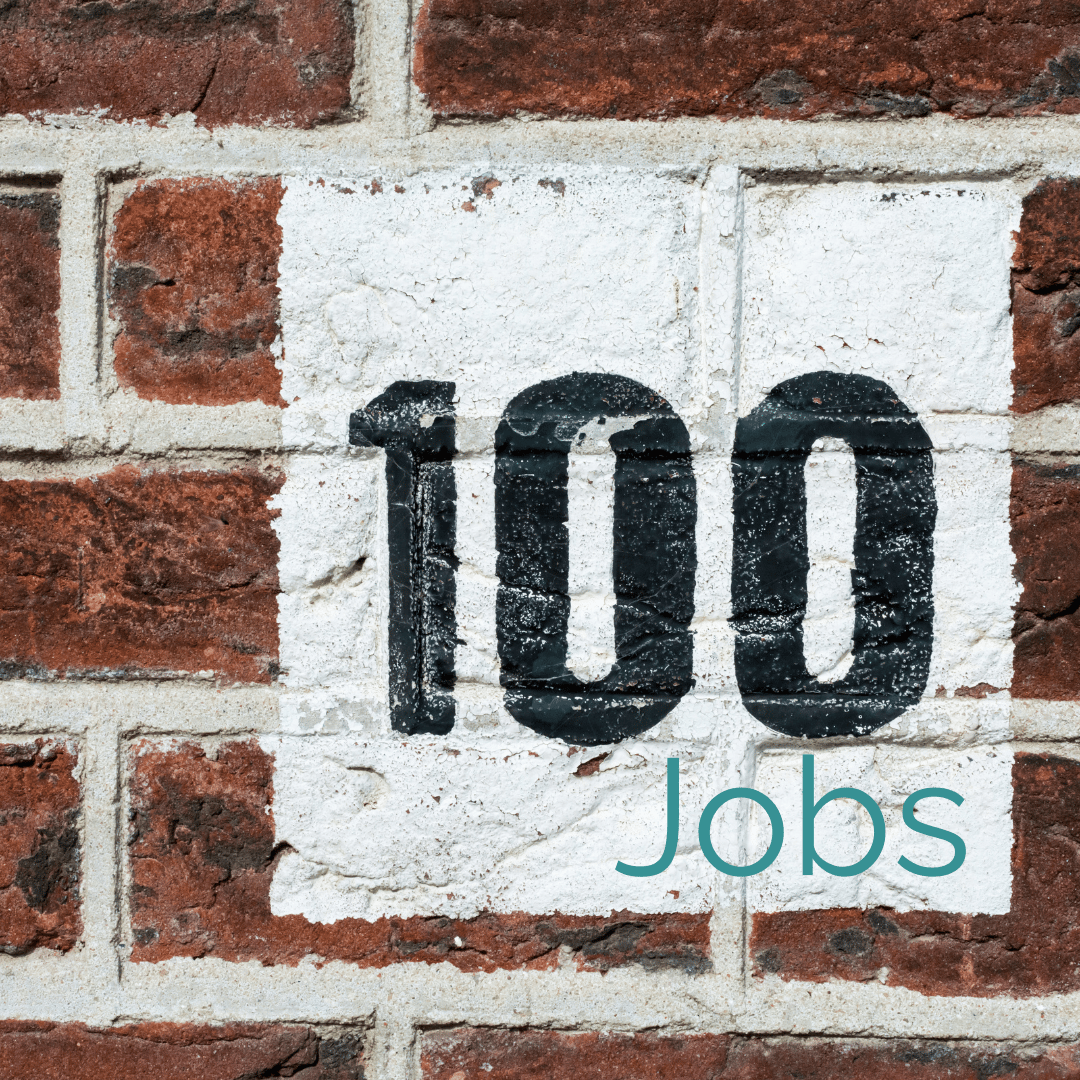 the number 100 is painted in black on a white square on a brick wall with teal word jobs below it