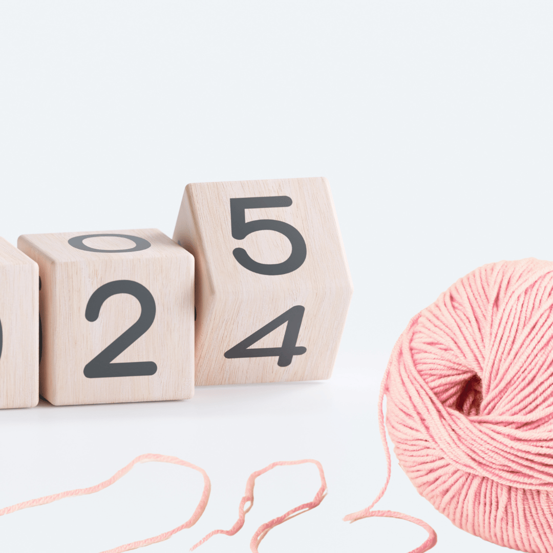 A yarn ball with the numbers 24 turning into 25 behind it