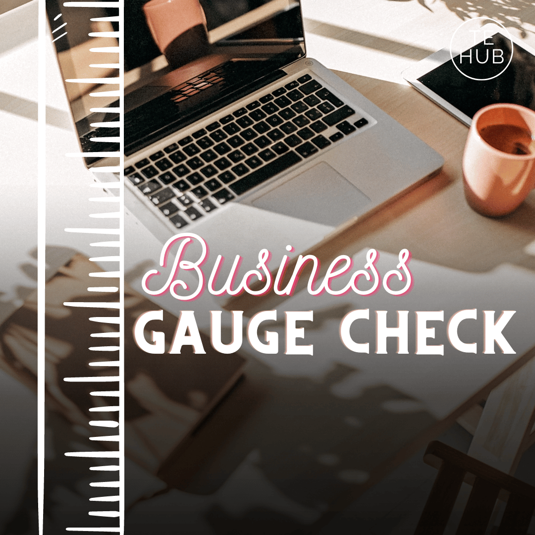 A laptop sits on a sunny desk next to a coral coffee cup, an image of a ruler is over the image with the words Business Gauge Check