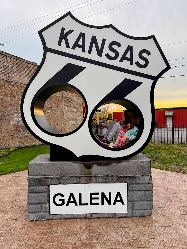 My daughter in a large Route 66 shield in Galena, Kansas