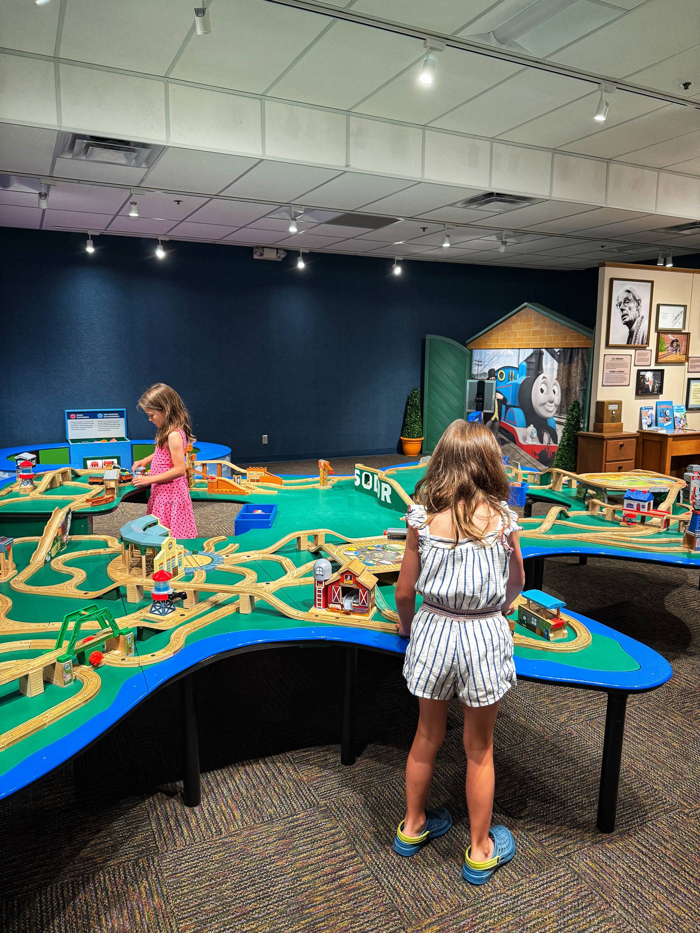 two girls playing with a train track set at Crown Center's free exhibit 
