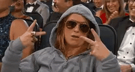 Woman flashing two peace signs while sitting in a chill state