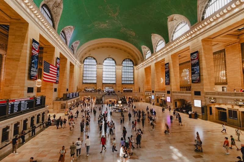 A group of people walking around a train station