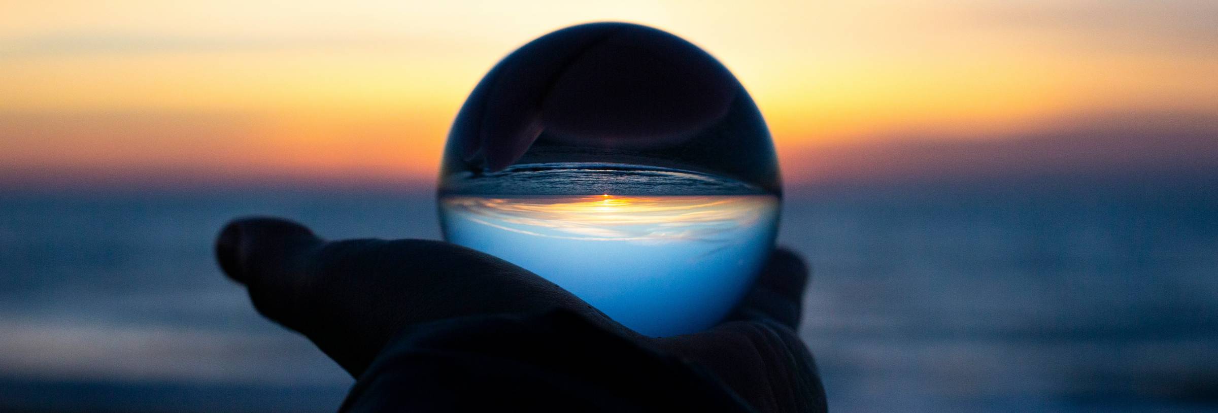 View of the sunset through a globe - focusing a vision transformed view of the vision