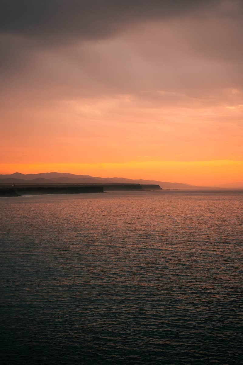 Sunset casts vibrant hues over the ocean.