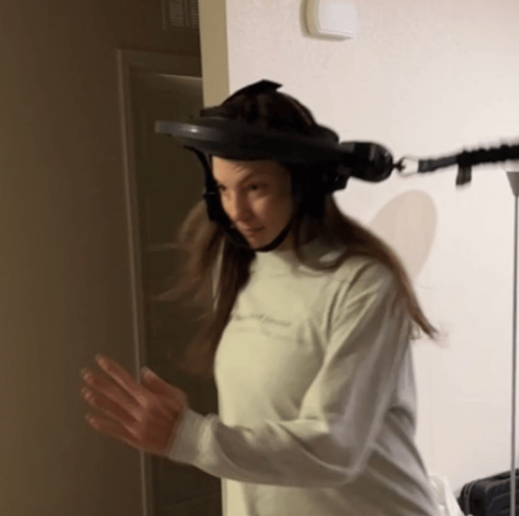 marlo appearing to run while her head is strapped into the Iron Neck