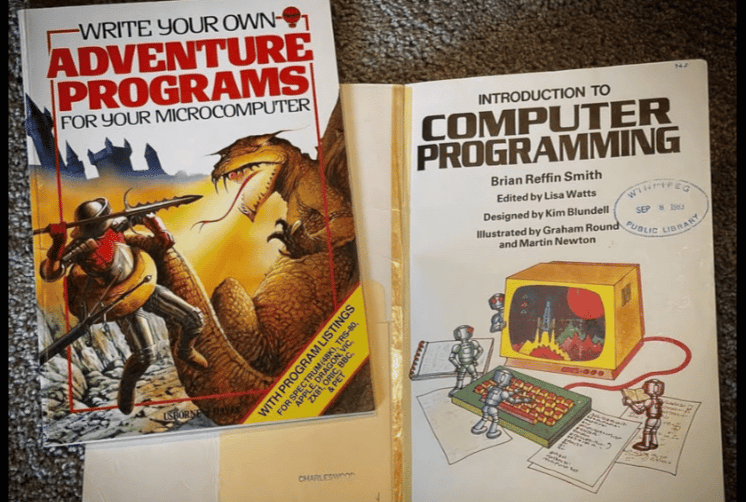 Usborne "Write Your Own Adventure Programs" and "Introduction to Computer Programming" open on a desk. Still for old microcomputers, but with a modern sensibility.
