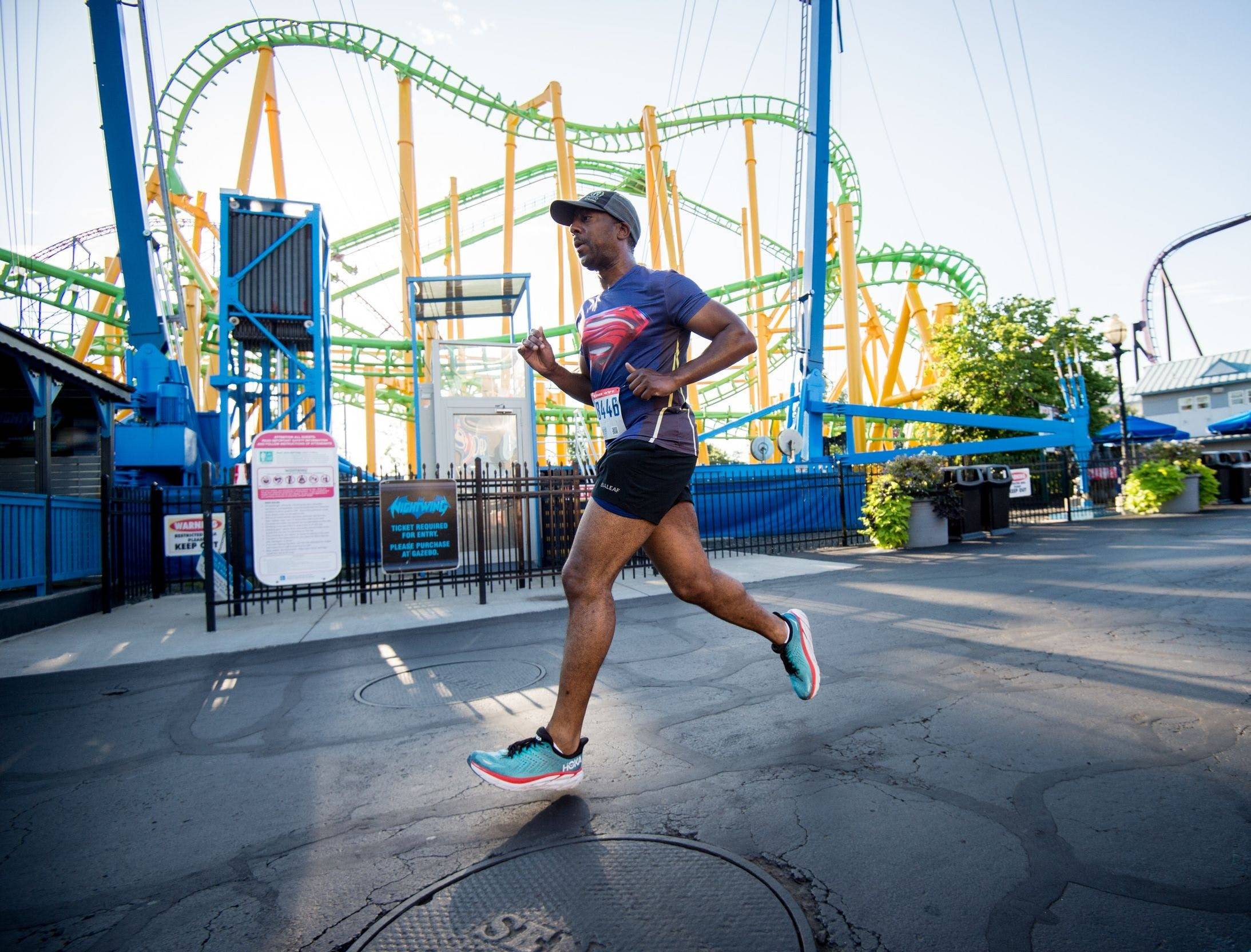 person in black and white nike athletic shoes standing on water