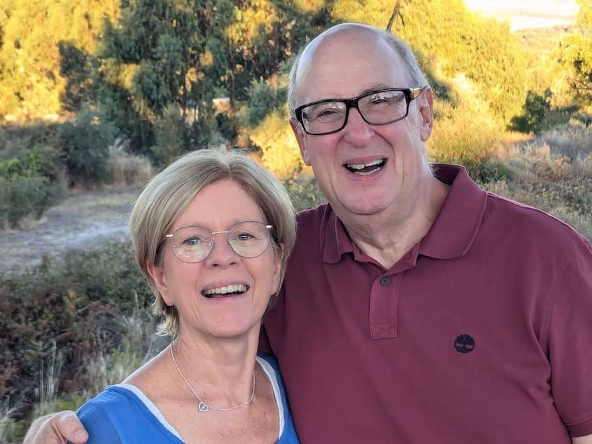 smiling couple against yellow flowered background