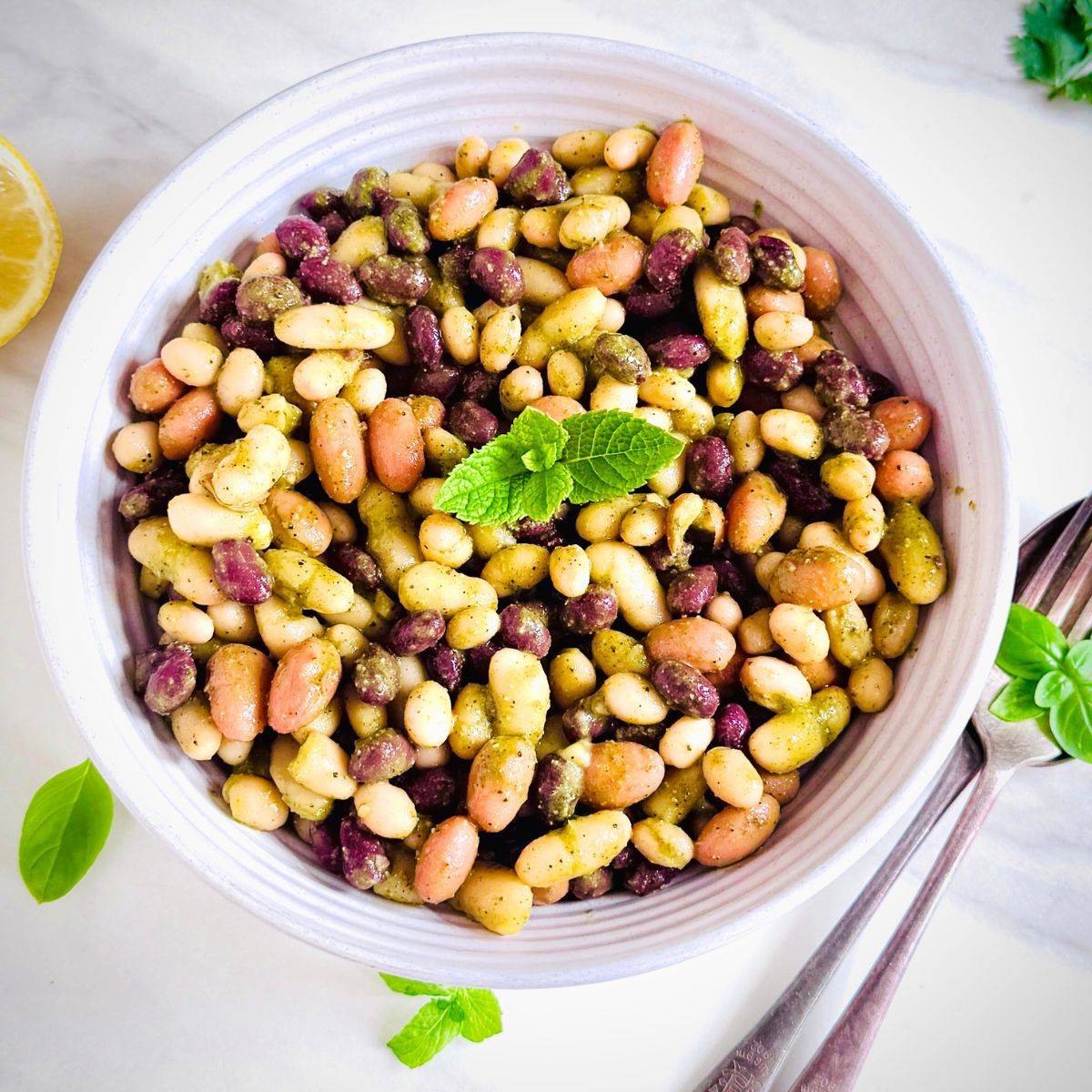 white bowl of mixed bean salad placed on 