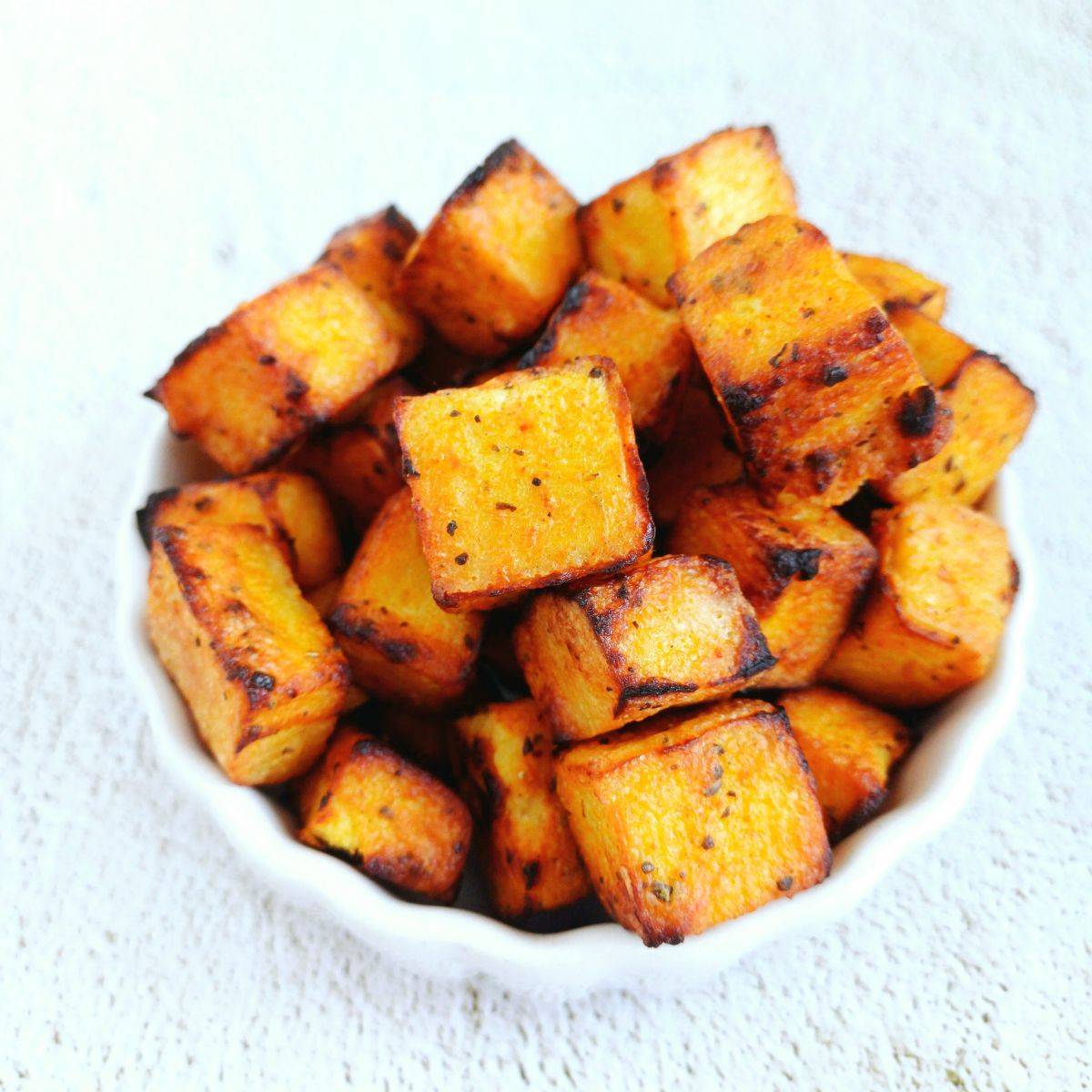 white bowl of yogurt marinated tofu placed on 