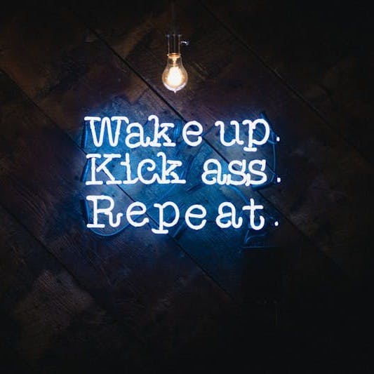 blue wake up kick ass repeat neon sign