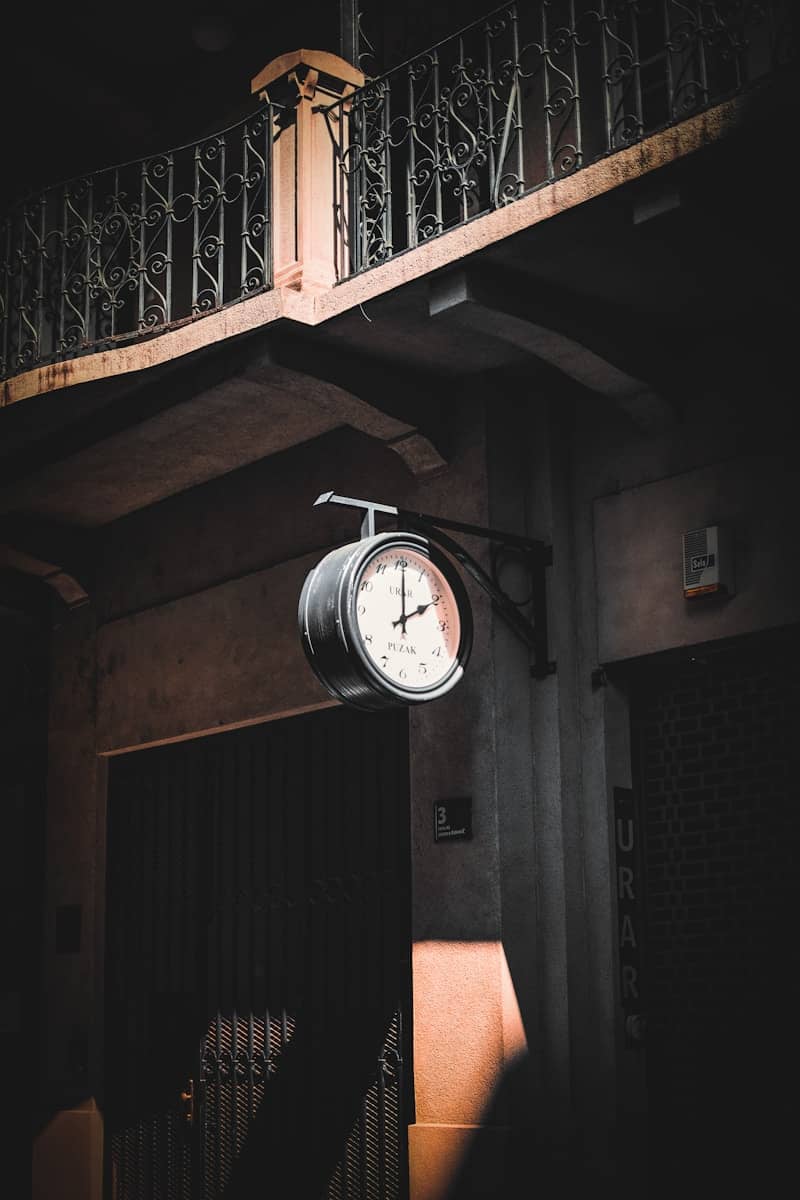 A clock hanging from the side of a building