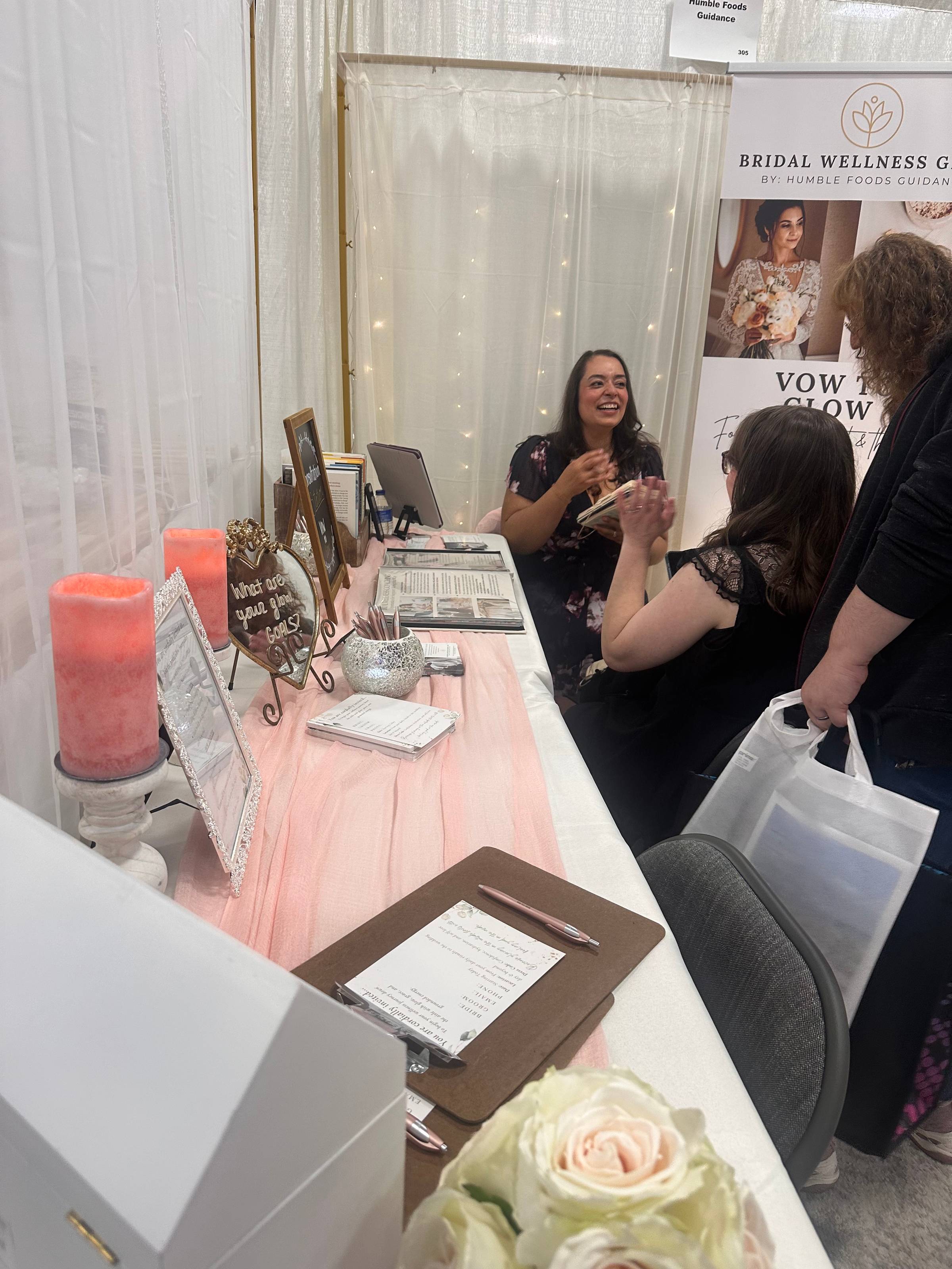 Mariana Santiago-Jimenez discussing wedding wellness with attendees at a New Jersey bridal show