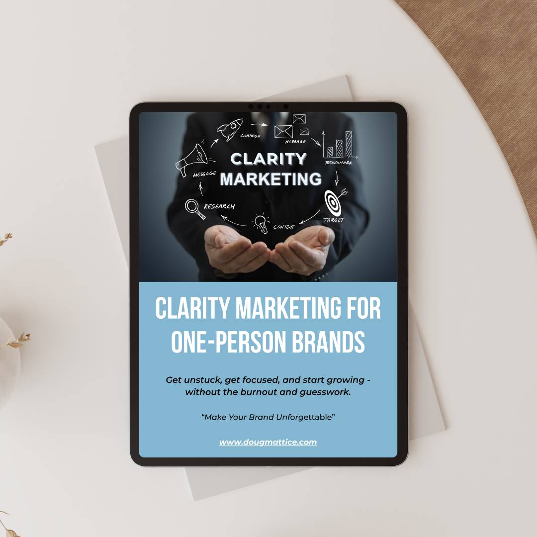Tablet showing the title of our free resource: "Clarity Marketing For One Person Brands." Click on the link to download.