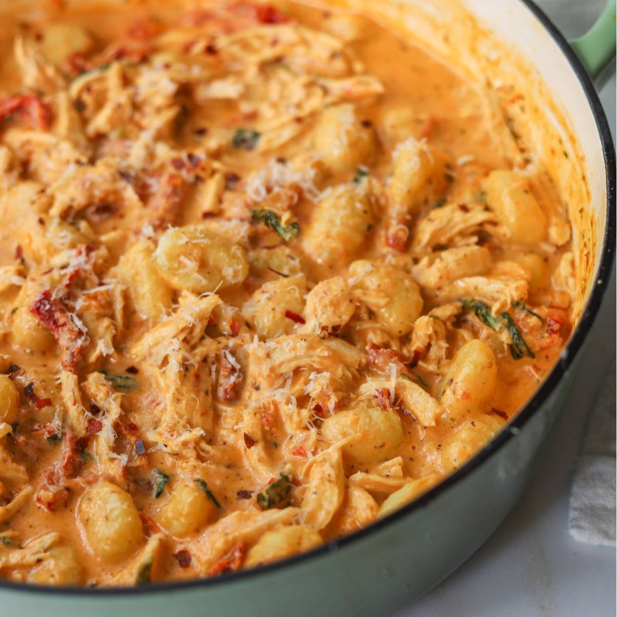 Sun dried tomato chicken gnocchi in a pan.