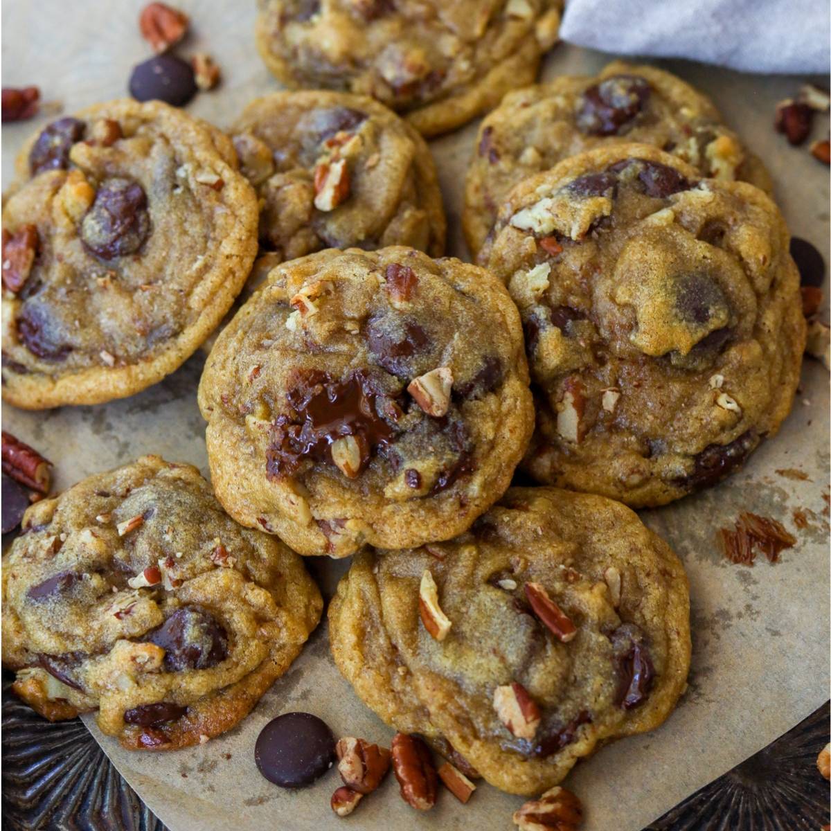 Chocolate chunk pecan cookies in a pile.