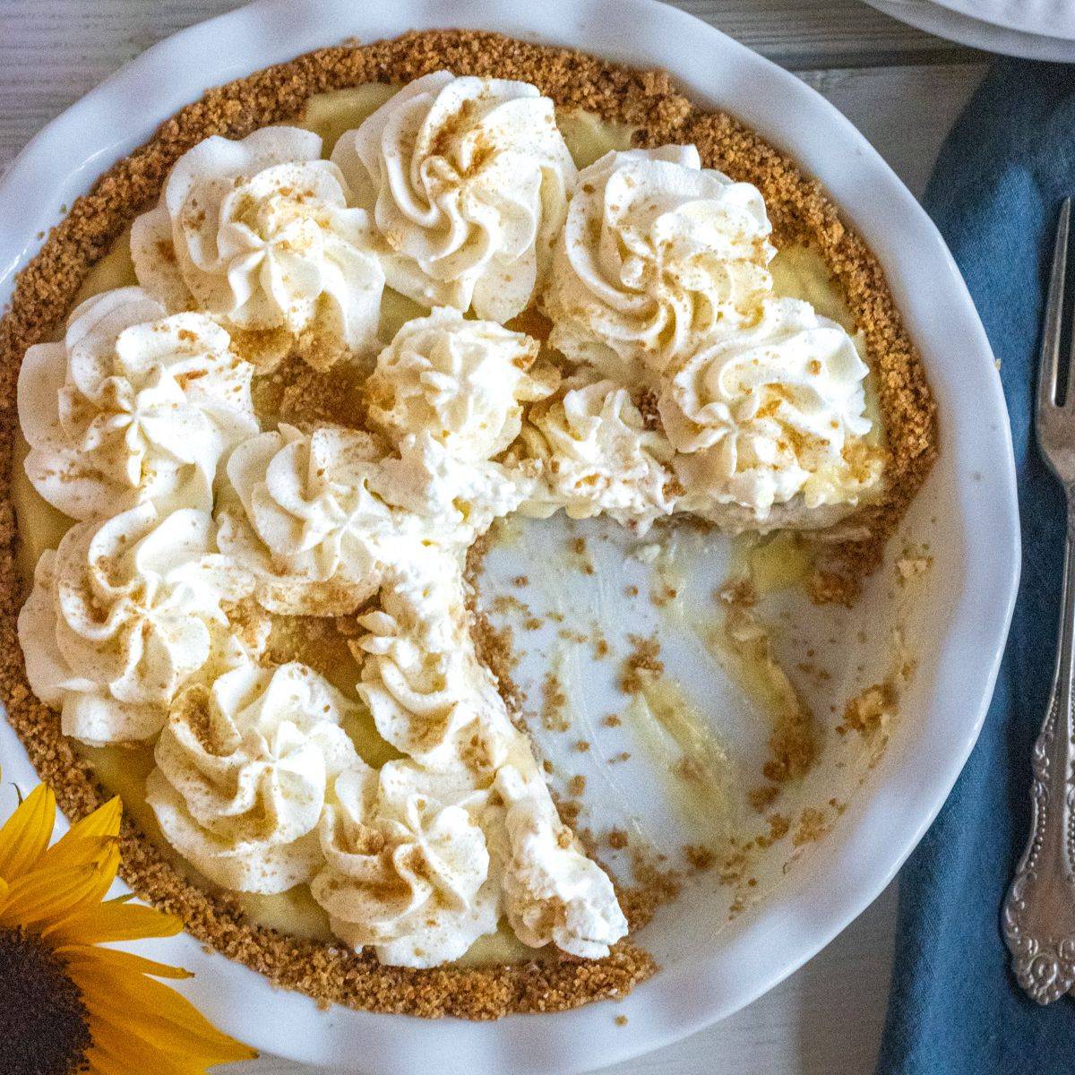 Pineapple cream pie in a baking dish with a slice missing.
